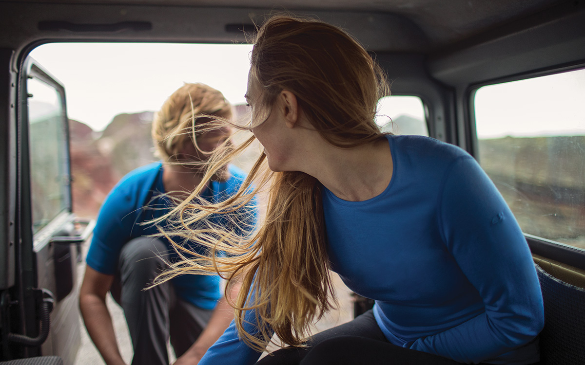 A woman wearing a Mountain Equipment jacket and helmet climbing