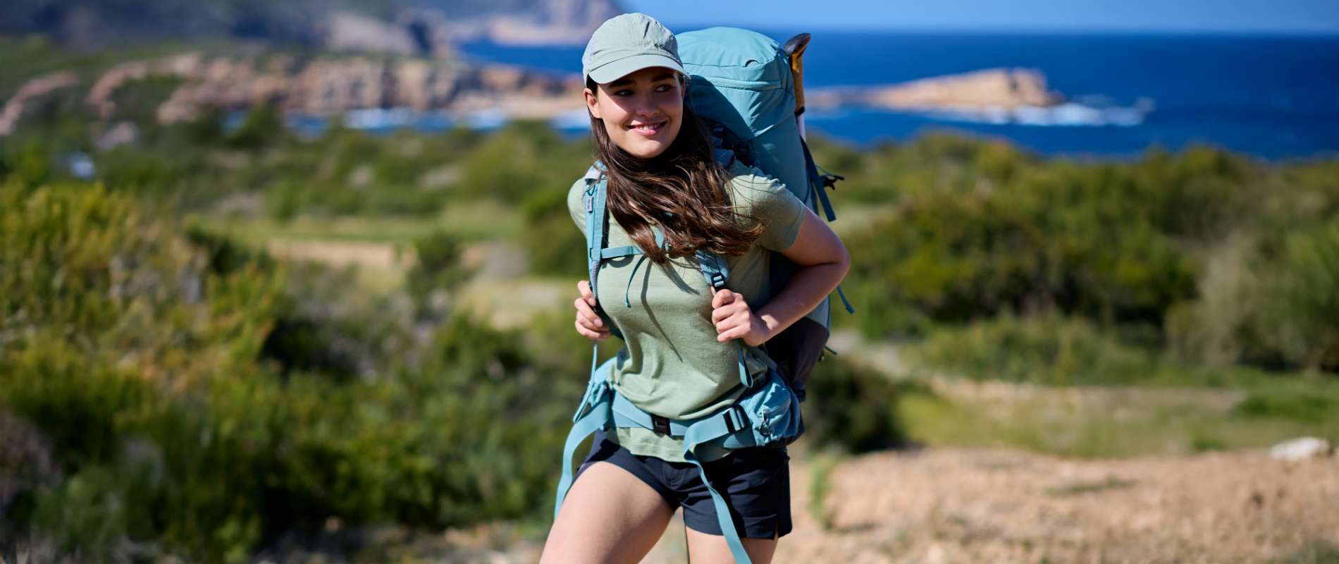 Man hiking with walking poles and backpack