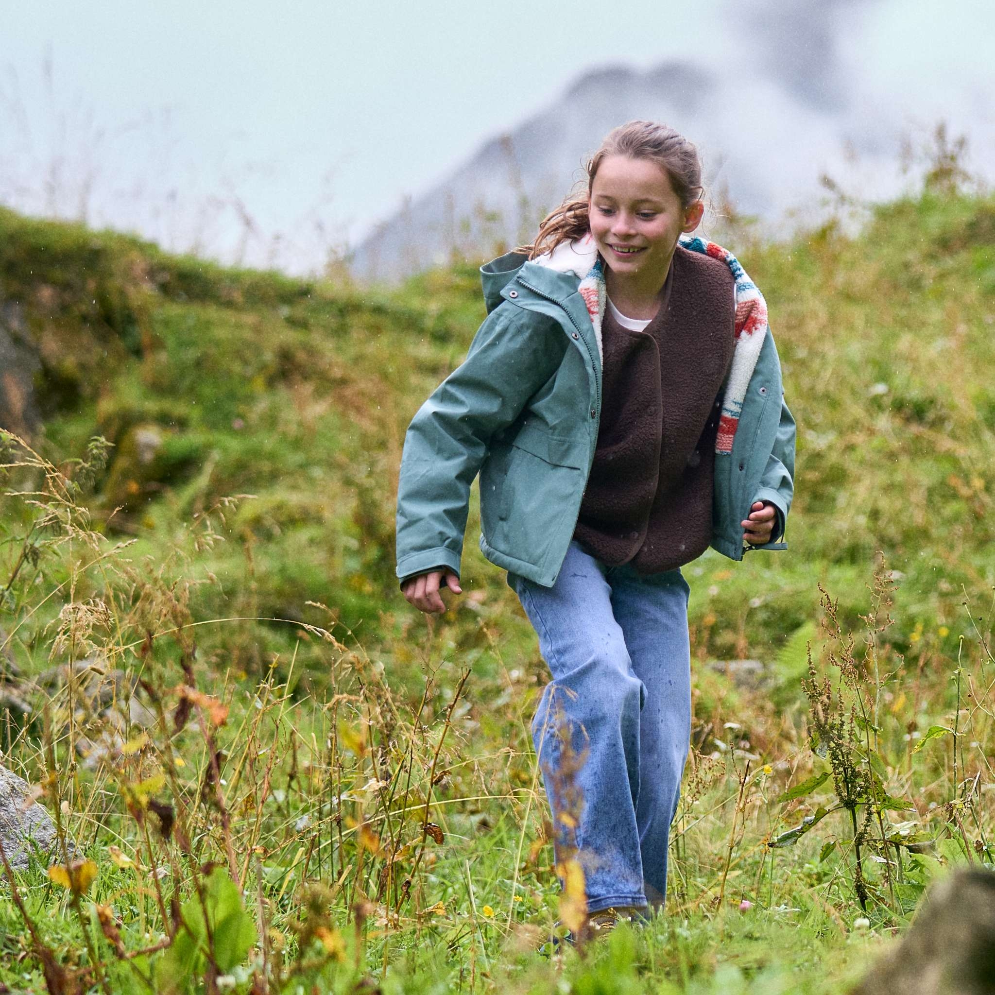 Girl smiling and playing in the mountains