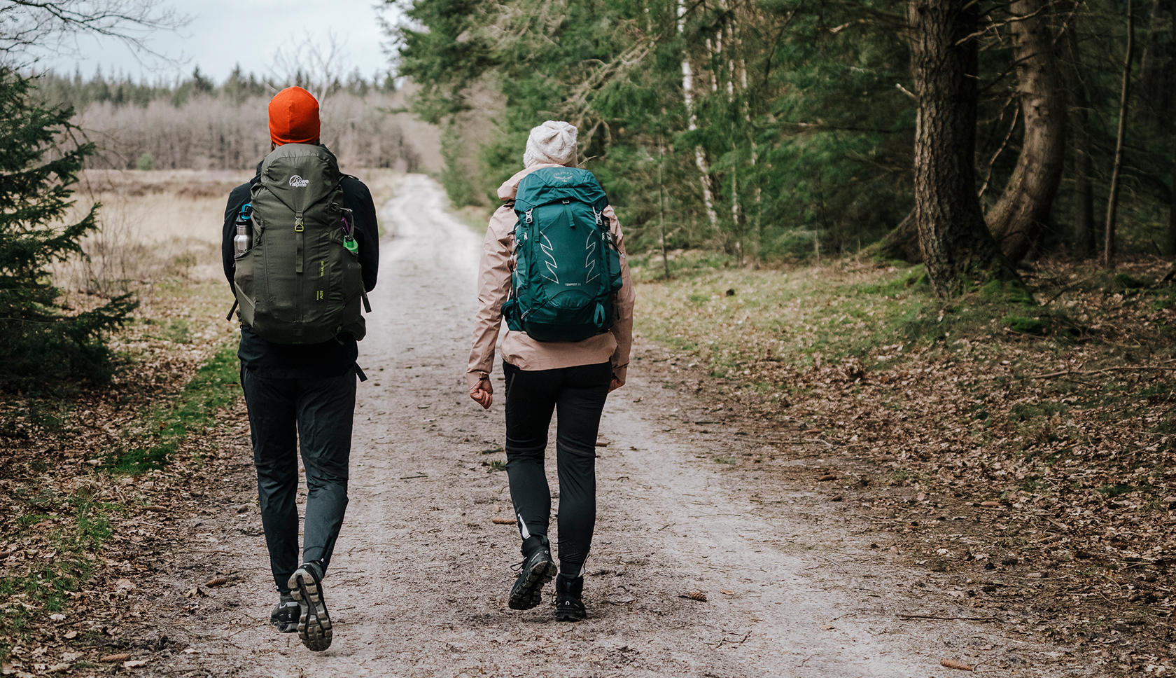 A woman and a man are pitching a tent