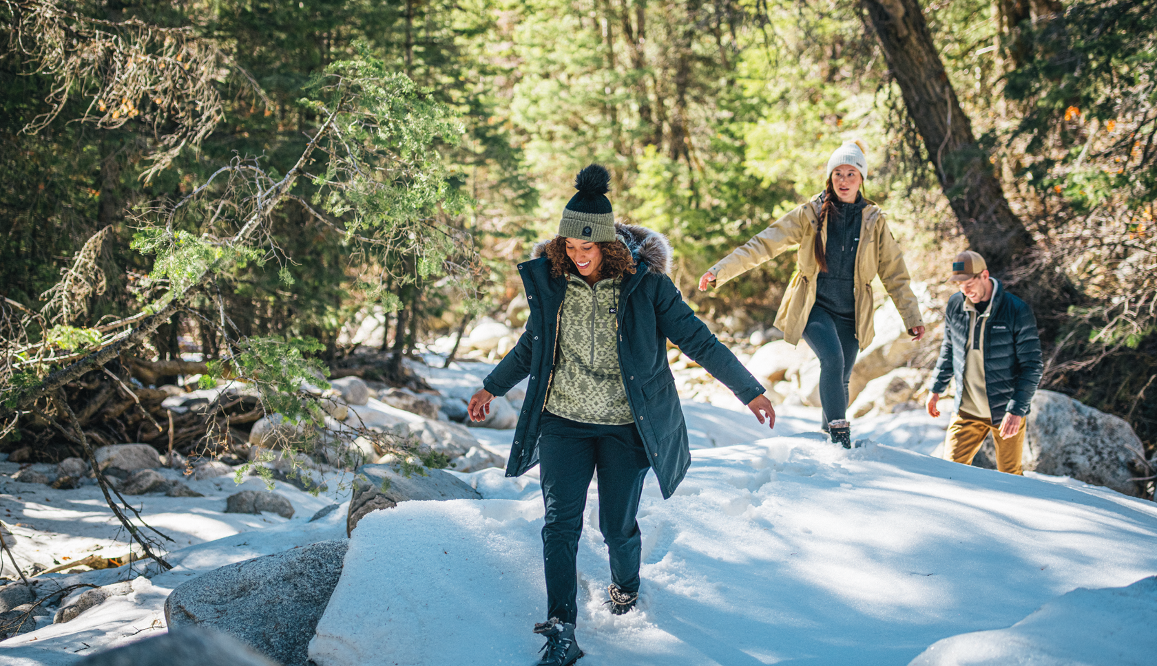 A woman wearing a Mountain Equipment jacket and helmet climbing