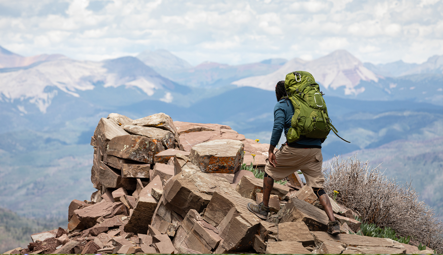Man wearing a green Osprey backpacks