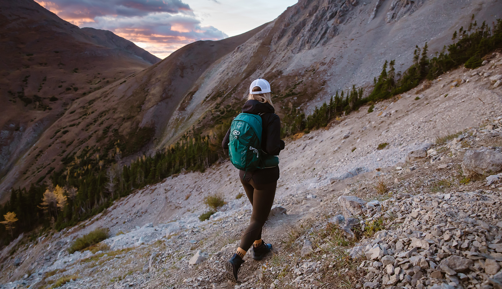 Woman wearing a green Osprey backpack