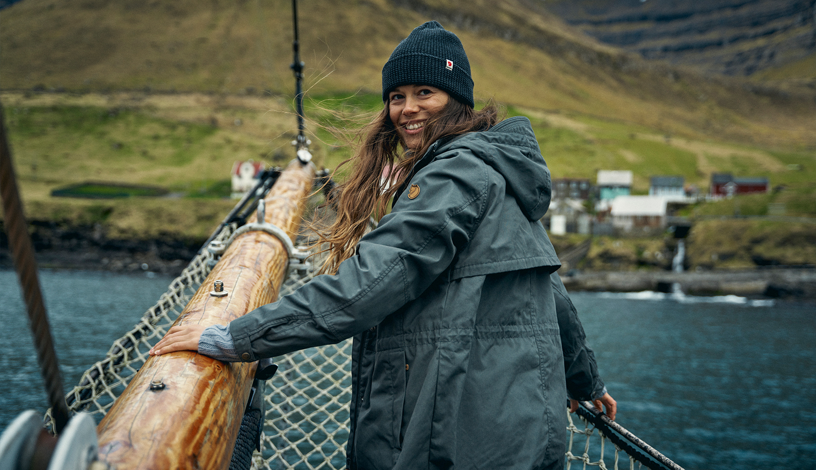 A woman wearing a Mountain Equipment jacket and helmet climbing