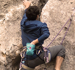 Woman Climbing A Rockface