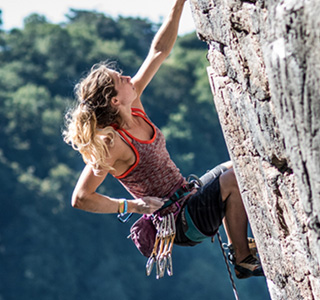 Woman Climbing A Rockface