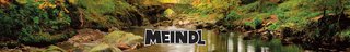 A view of some water surrounded by rocks, stones, and plants with Meindl brand logo in the middle.