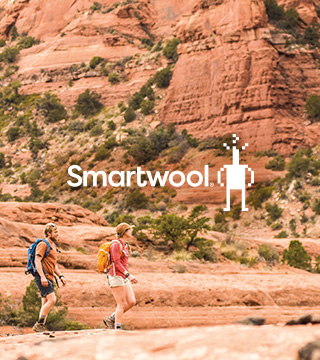 Two people walking in a deserted area wearing Smartwool socks