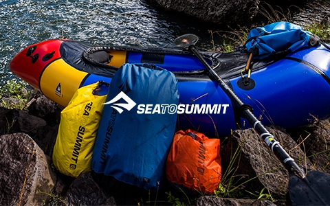 A man in Jack Wolfskin gear is not far from a sea.