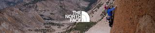 Man climbing rock face in North Face gear