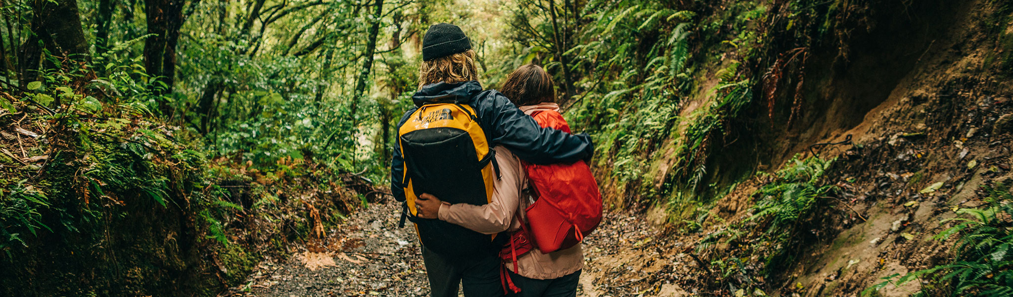 A woman wearing a Mountain Equipment jacket and helmet climbing