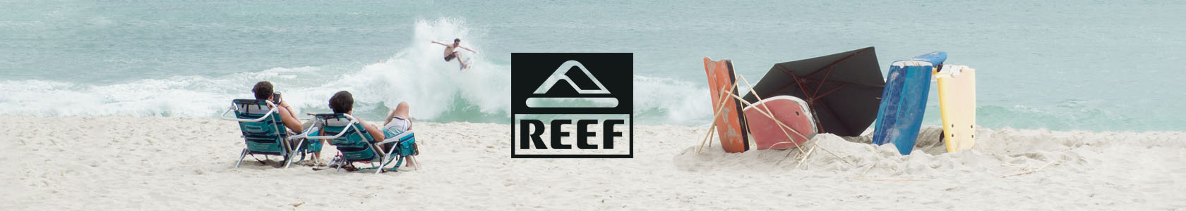 Surfer riding wave wearing Reef gear.