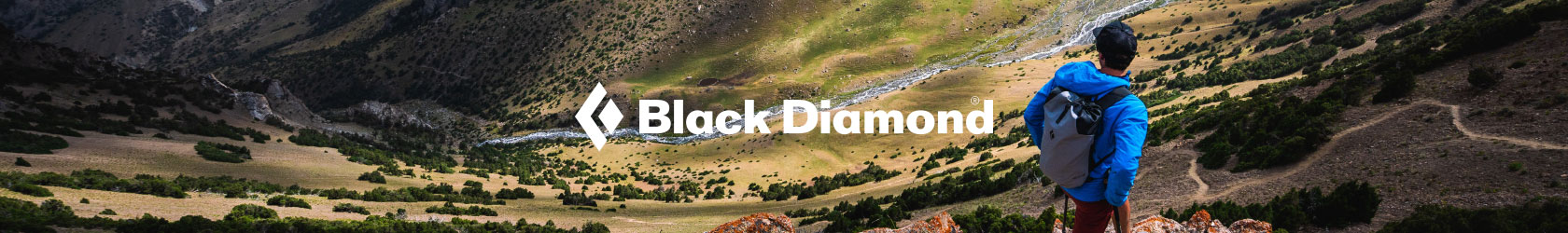 A man is climbing on a rock, wearing and using Black Diamond gear