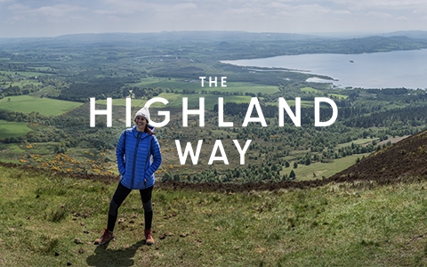 The Highland way - a woman is standing on a hill, wearing Columbia gear.