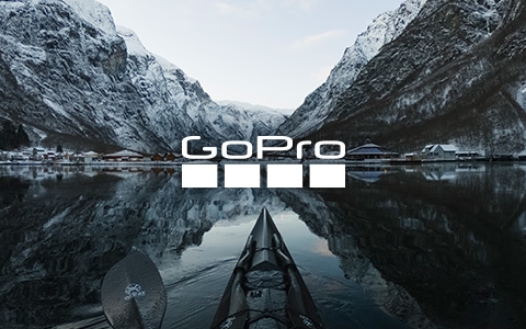 Snow mountains and a settlement, surrounded by mountains on one side and by a lake on another, with the GoPro logo in the middle of the image.