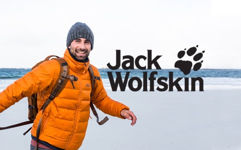 A man in Jack Wolfskin gear is not far from a sea.