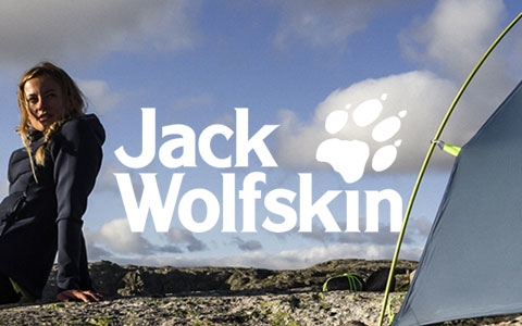 A man in Jack Wolfskin gear is not far from a sea.