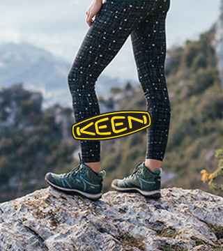 Woman standing on a mountain wearing Keen Terradora boots.