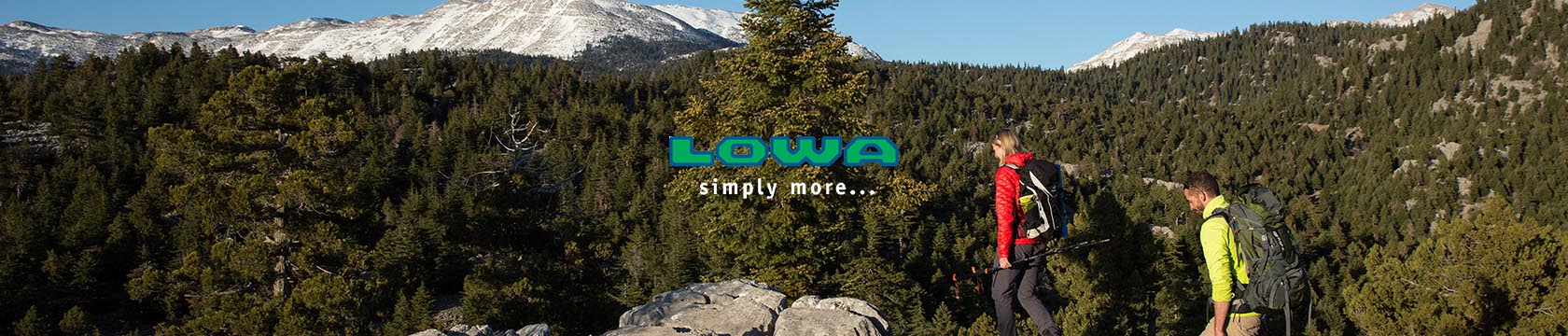 Man lying on a ledge wearing Lowa gear.