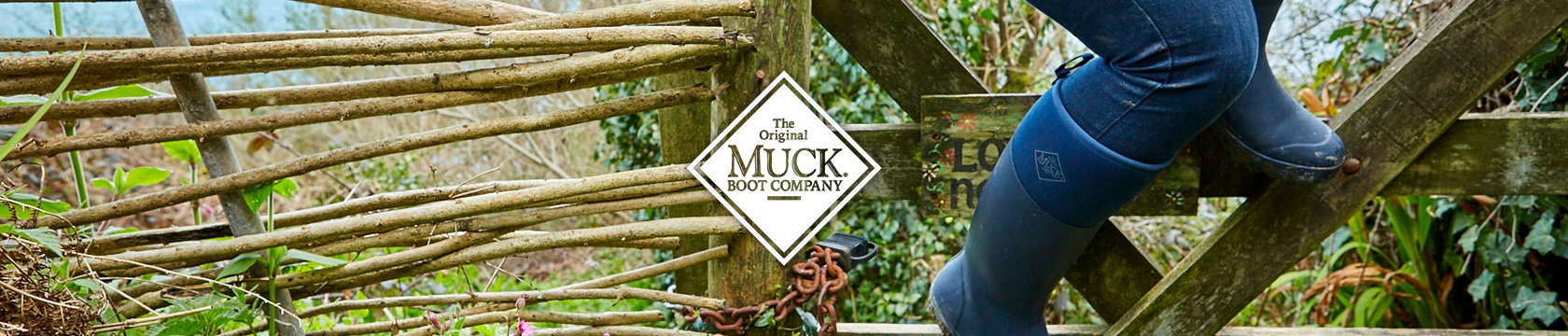 Person climbing wooden stairs, wearing Muck Boot boots.