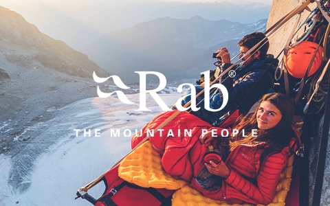 People wearing and using Rab gear are hanging on a snow mountain and enjoying interesting snow views and a drink.