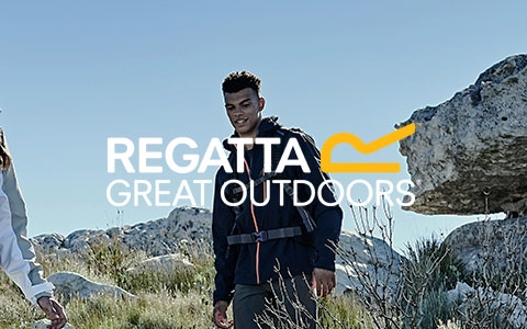 People are walking next to rocks, carrying backpacks and wearing Regatta jackets