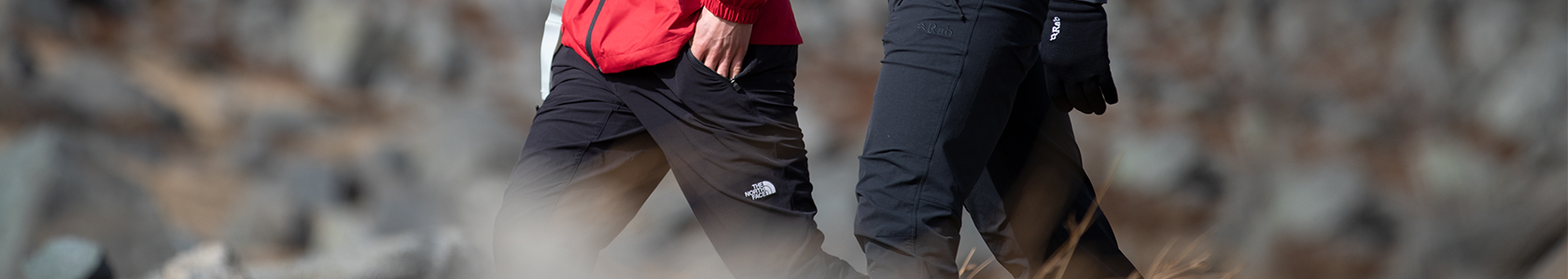 An image of two men walking in hiking trousers 
