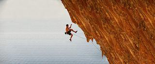 Man Abseiling Down a Rock Face