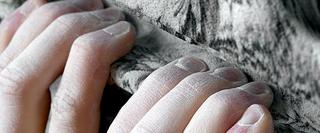 Fingers gripping ledge