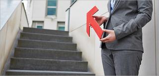 woman with red arrow pointing up some stairs
