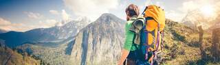 Man looks out across a mountain range