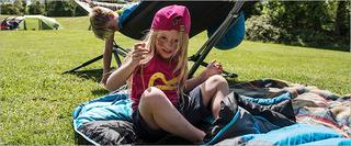 Child sitting on sleeping bag