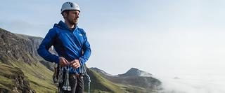Man standing on mountain with climbing gear
