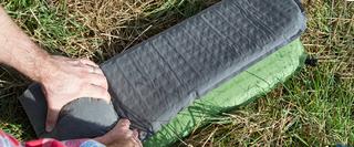 camping mat being rolled away