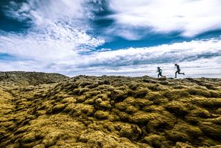Couple Running Through the Icelandic Landscape