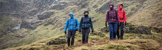 Group walking down mountain in waterproofs