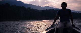 Man on Boat with sun setting