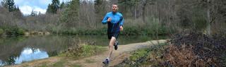 Man runs through forest