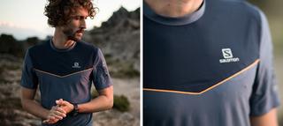 Man standing on a rock at sunset in a running t-shirt