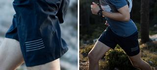 Man running through forest in work out wear, emphasis on his blue shorts