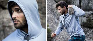 Man in Grey hoodie, carrying a rock on his shoulder running up more rocks