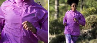 Woman running through forest in lightweight running jacket