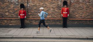 Woman running past guards