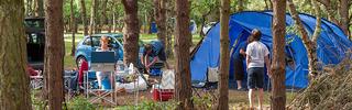 Family at wooded campsite