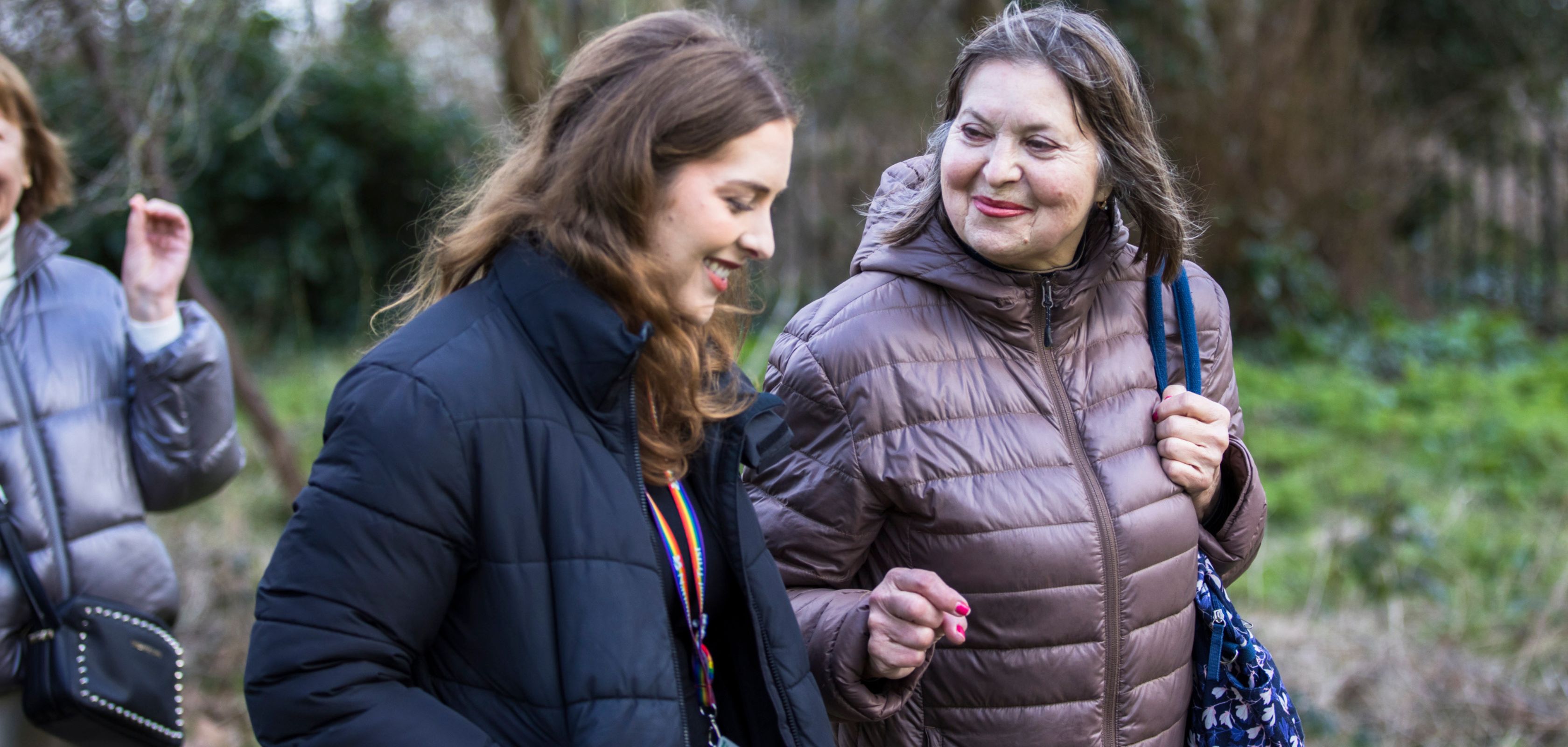Two women smiling and walking outdoors