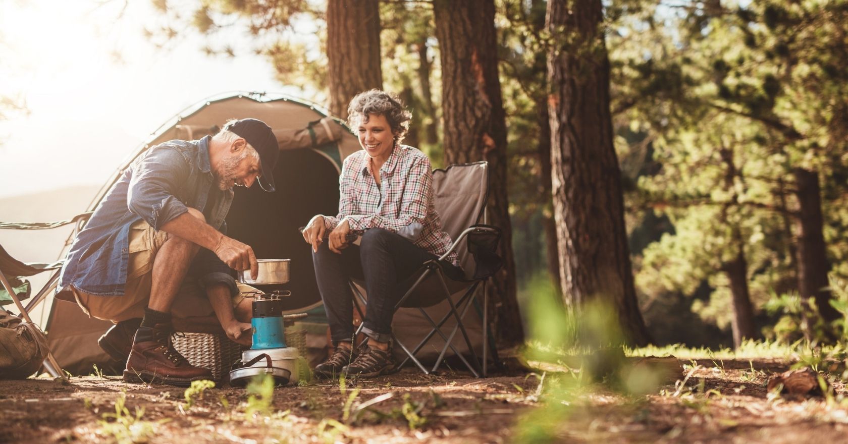 A couple cooking on their camp stove 