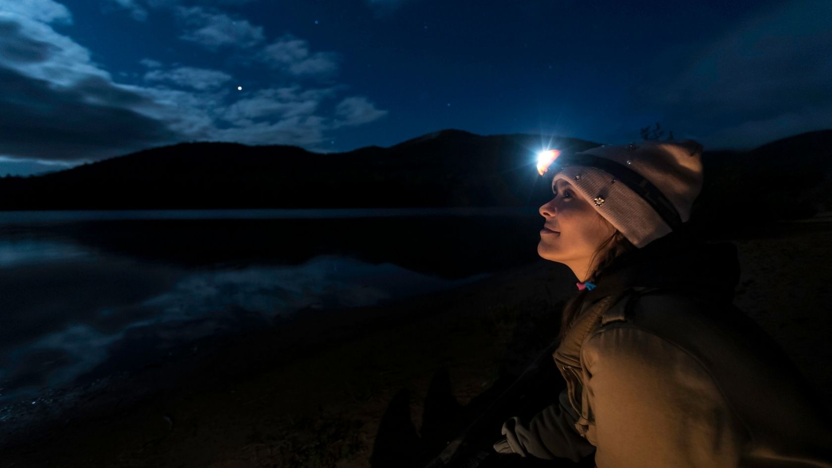 Woman wearing a headtorch at night