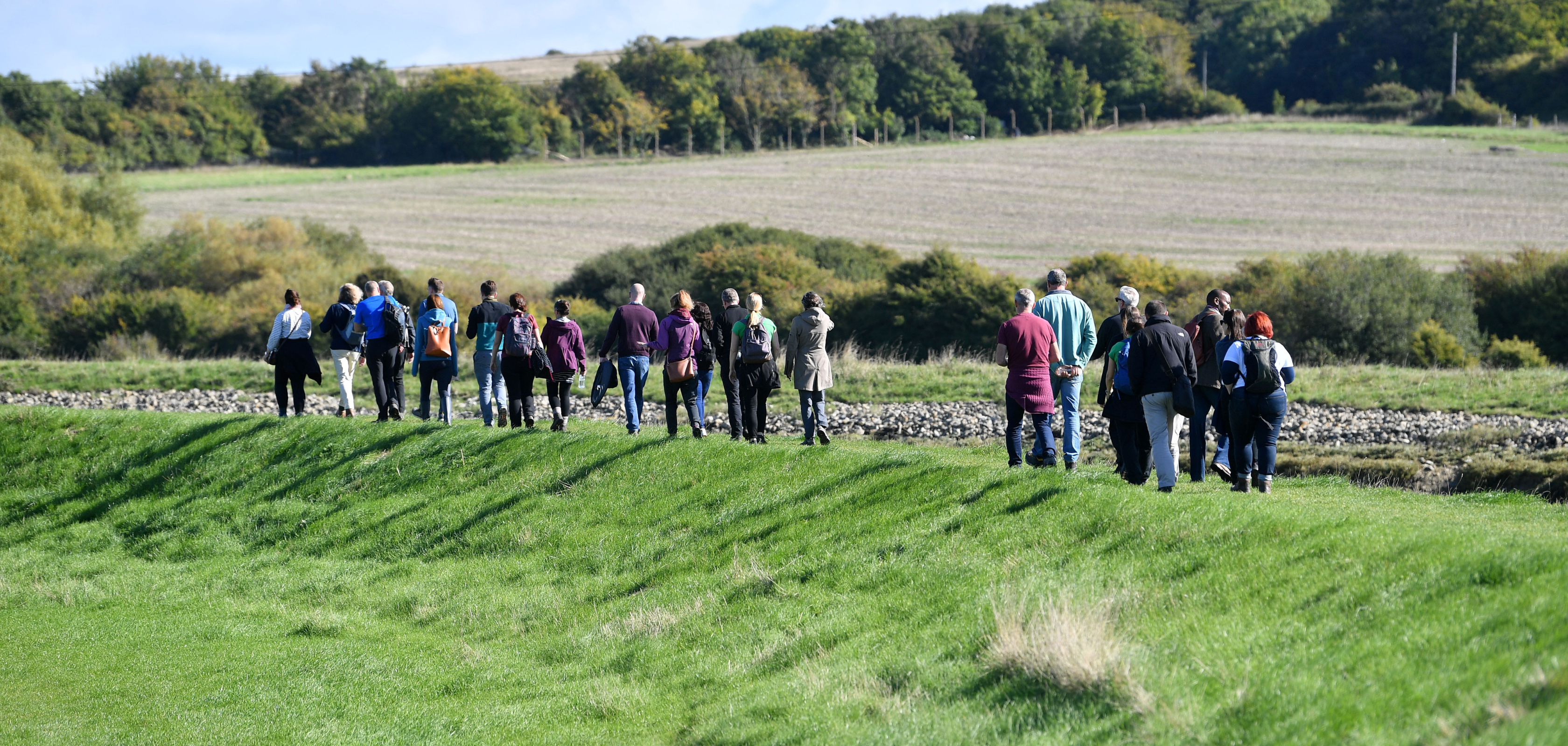 A group of people walking in the countryside