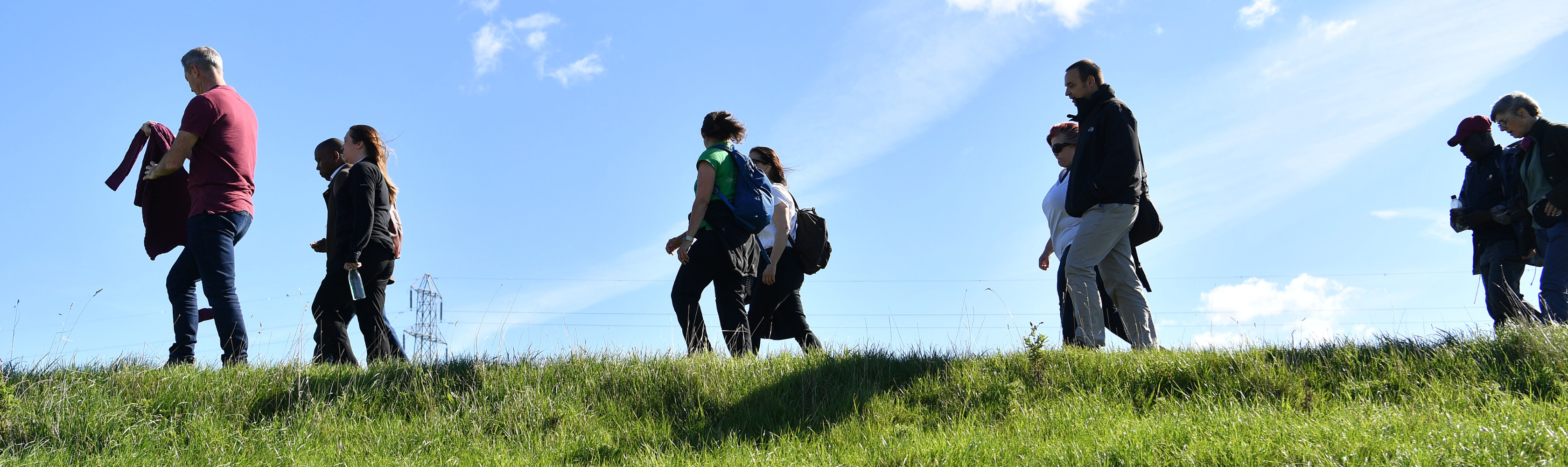 People walking together over a hill