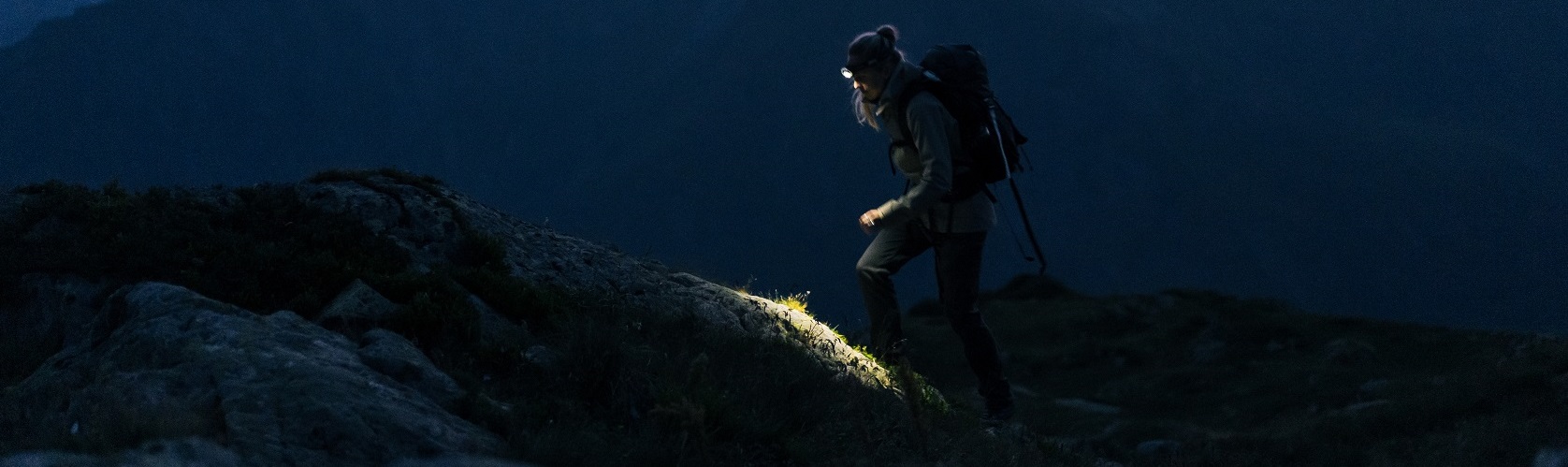A person wearing a head torch in the dark 